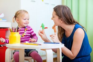 Daycare worker entertaining child - Career opportunities at First Path Day Care Center